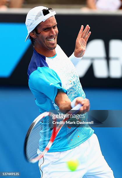 Juan Ignacio Chela of Argentina plays a forehand in his third round match match against David Ferrer of Spain during day six of the 2012 Australian...