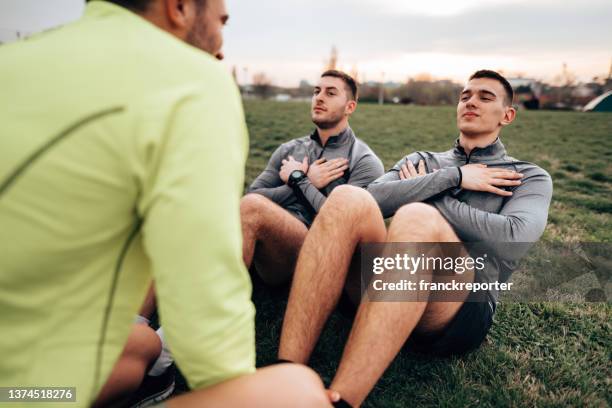 friends doing abs together at the park - boot camp stock pictures, royalty-free photos & images