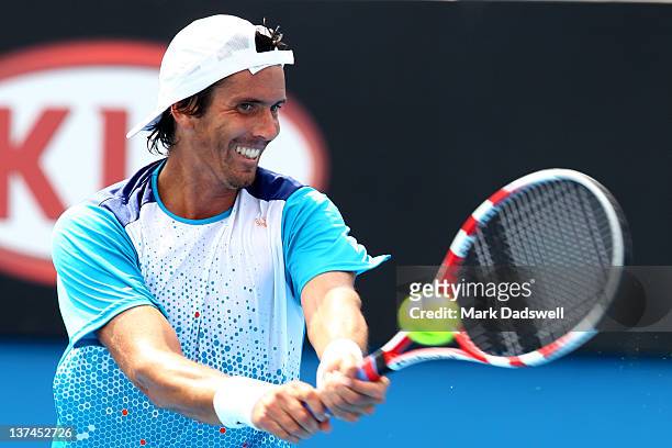 Juan Ignacio Chela of Argentina plays a backhand in his third round match match against David Ferrer of Spain during day six of the 2012 Australian...