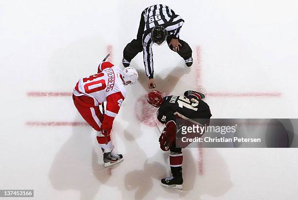 Henrik Zetterberg of the Detroit Red Wings faces off against Boyd Gordon of the Phoenix Coyotes during the NHL game at Jobing.com Arena on January...