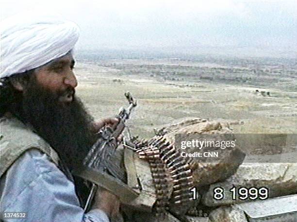 This image taken from a video obtained by CNN shows a member of the Taliban or al Qaeda's elite fighting group "Force 055" as he talks about fighting...