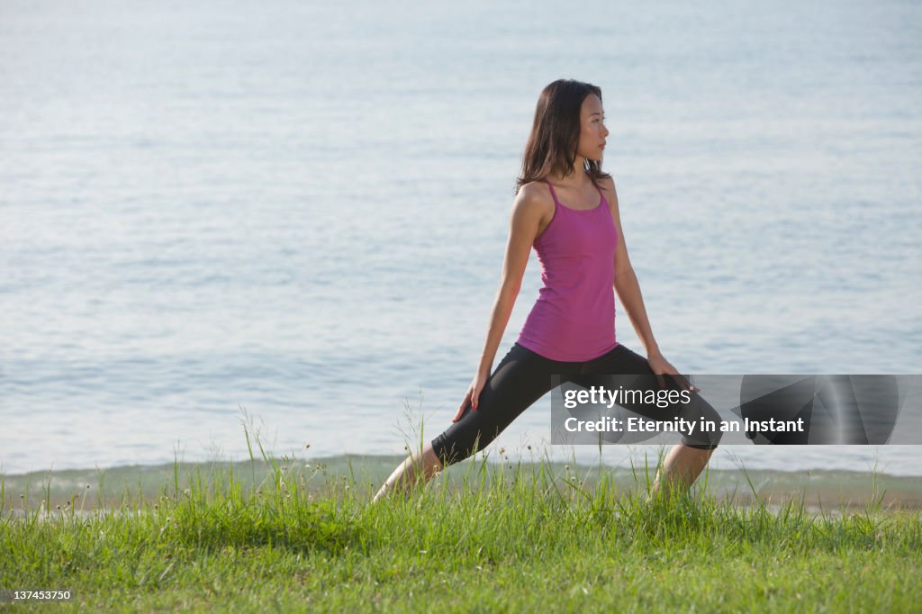 Woman stretching by the sea