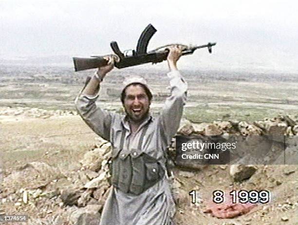 This image taken from a video obtained by CNN shows a member of al Qaeda's elite fighting group "Force 055" as he celebrates the taking of Bagram Air...