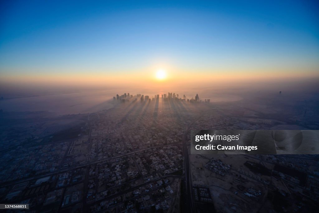 Doha skyline at sunrise with morning fog