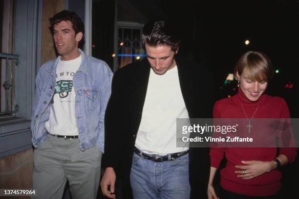 American actor William Baldwin, wearing a black jacket over a white t-shirt and jeans, with his partner, American singer and actress Chynna Phillips,...