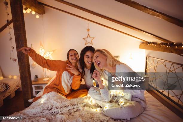 female friends having good time on a sleepover - college dorm party stock pictures, royalty-free photos & images