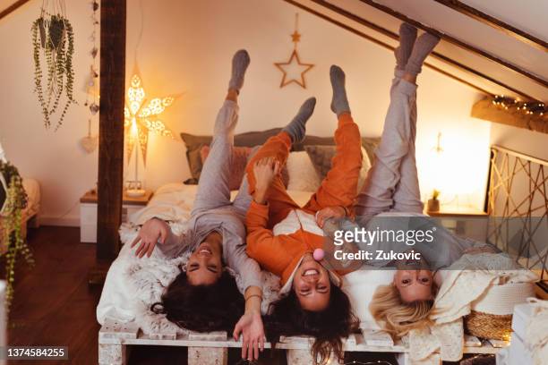 female friends pyjama party - college dorm party stock pictures, royalty-free photos & images