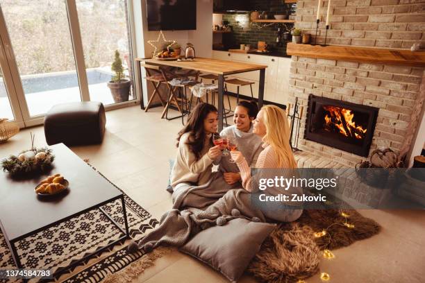 beautiful evening enjoying wine by the fireplace - cosy fireplace stock pictures, royalty-free photos & images