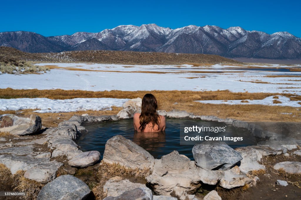 Female soaking in natural hot springs