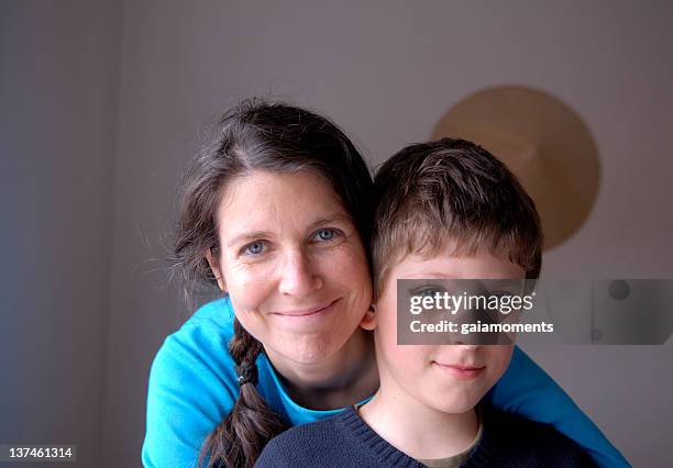 woman hugging young son close up - dna smiley stock pictures, royalty-free photos & images