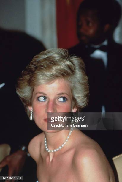 British Royal Diana, Princess of Wales , wearing a pearl necklace and pearl earrings, attends a State Dinner at Yaoundé Unity Palace in Yaounde,...