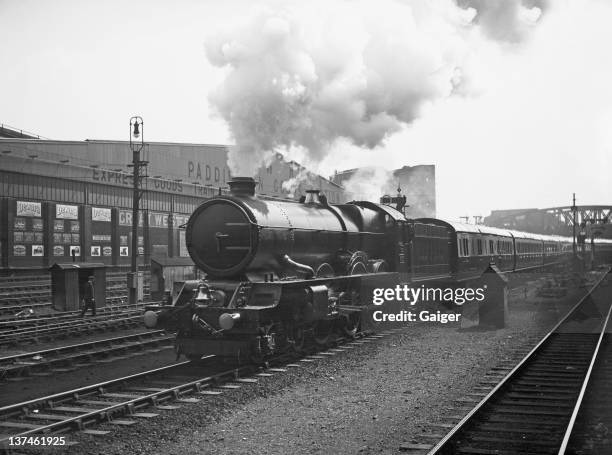 The Great Western Railway 6000 Class King George V steam locomotive hauling the Cornish Riviera express out of Paddington Station, London, 8th July...