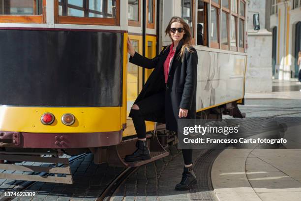 young female tourist riding tram in lisbon - lisbon people stock pictures, royalty-free photos & images