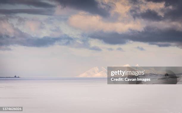 clouds floating over longyearbyen bay - arctic stock pictures, royalty-free photos & images