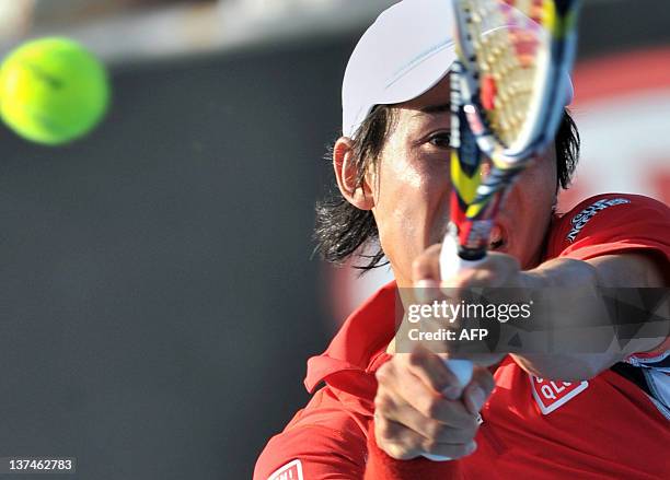 Kei Nishikori of Japan hits a return against Julien Bennetteau of France in their third round men's singles match on day six of the 2012 Australian...