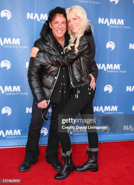 Recording artist Neal Schon of Journey and TV personality Michaele Salahi attend the 110th NAMM Show - Day 2 at the Anaheim Convention Center on...
