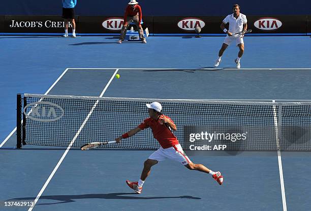 Kei Nishikori of Japan hits a volley against Julien Bennetteau of France in their third round men's singles match on day six of the 2012 Australian...