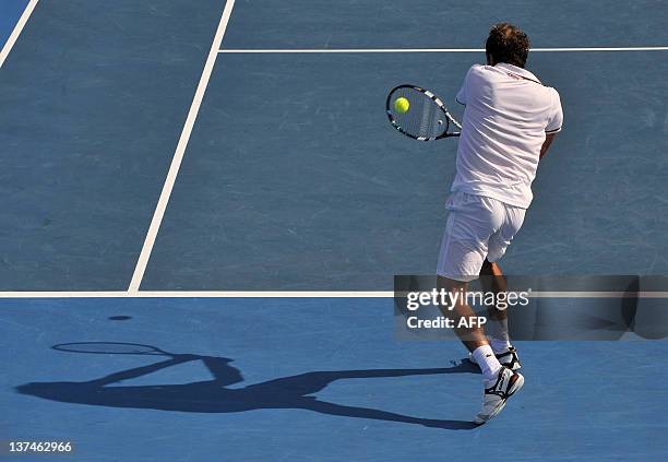 Julien Bennetteau of France hits a return against Kei Nishikori of Japan in their third round men's singles match on day six of the 2012 Australian...