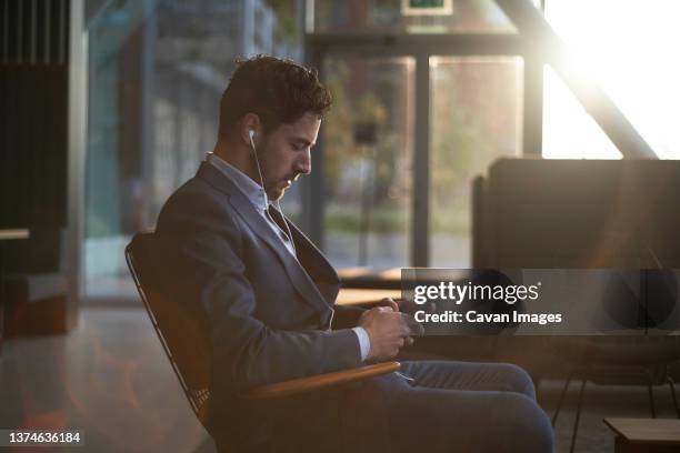 man wearing a suit waiting for his job interview - phone interview event stock pictures, royalty-free photos & images