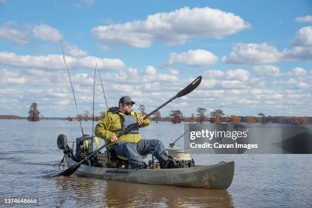 large man paddling kayak in lake - caddo lake stock pictures, royalty-free photos & images