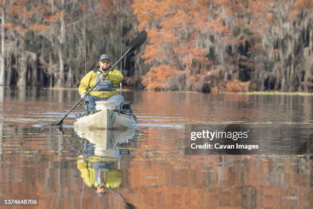 man paddling kayak in lake - caddo lake stock pictures, royalty-free photos & images