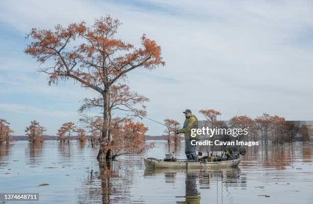 man fishing on lake in fall - caddo lake stock pictures, royalty-free photos & images