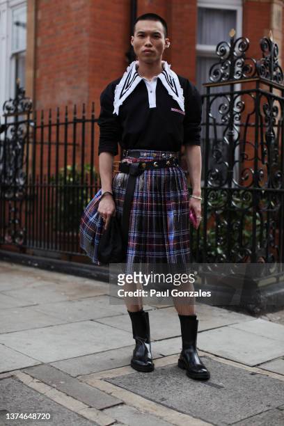 Guest is seen wearing a Kilt with a Knitted Navy Jumper. At Poster Girl, during London Fashion Week February 2022 on February 18, 2022 in London,...
