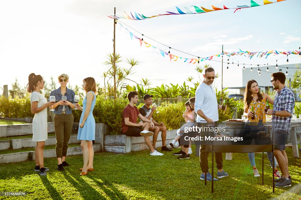 People enjoying Asado party at backyard