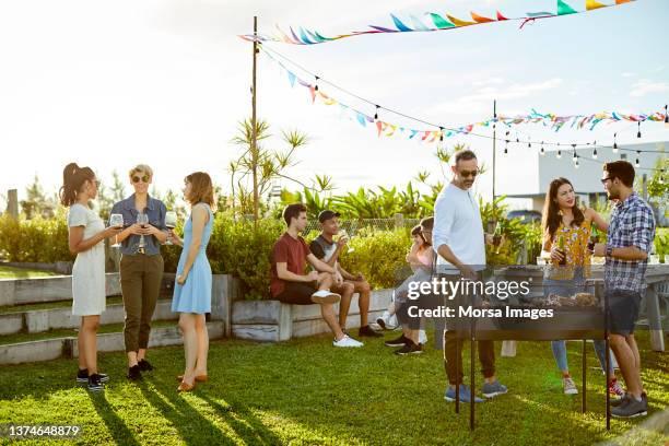 people enjoying asado party at backyard - party fotografías e imágenes de stock