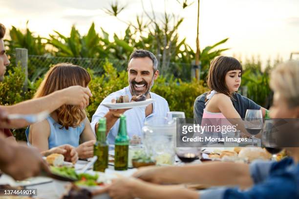 males and females celebrating asado in backyard - argentina wine stock pictures, royalty-free photos & images