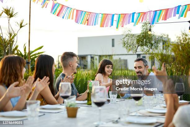 girl giving cake to father during party - 40 birthday foto e immagini stock