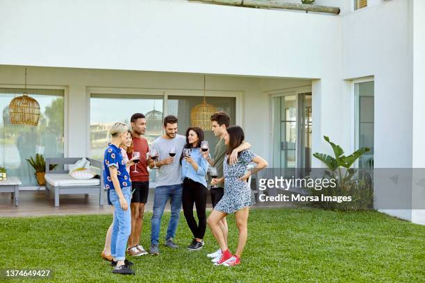 friends enjoying social gathering in backyard - saturday stock pictures, royalty-free photos & images
