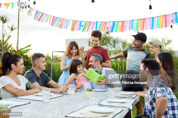 man enjoying birthday with daughter and friends - 40 birthday foto e immagini stock