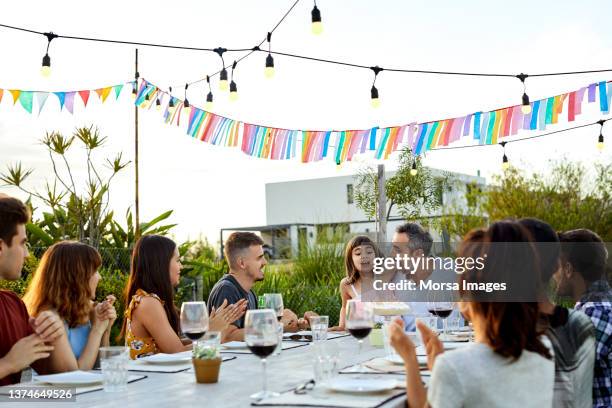 man with daughter and friends at table in yard - argentina girls stock pictures, royalty-free photos & images