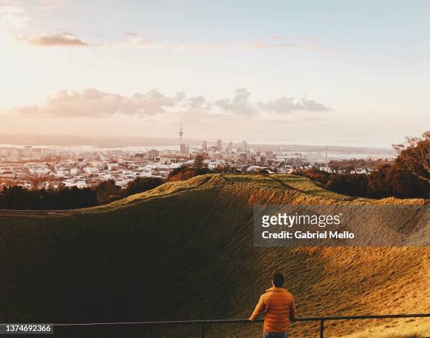 man watching sunset in mount eden - auckland stock pictures, royalty-free photos & images