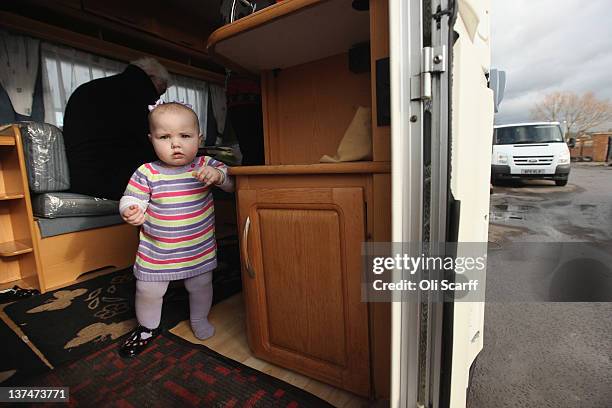 Former residents of the portion of the Dale Farm traveller's camp cleared by Basildon Council, relax in their caravan on the 'Oak Lane' site on...