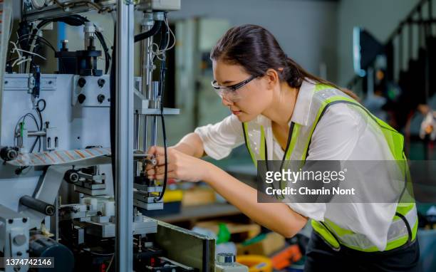 Woman industrial engineer while maintenance and check security system in factory.
