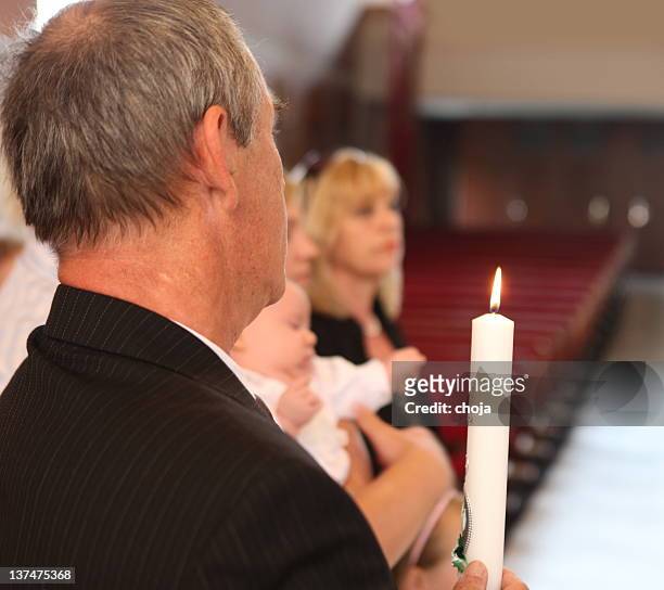 in church...baby,godmother and godfather waiting for baptism - baptism baby stock pictures, royalty-free photos & images