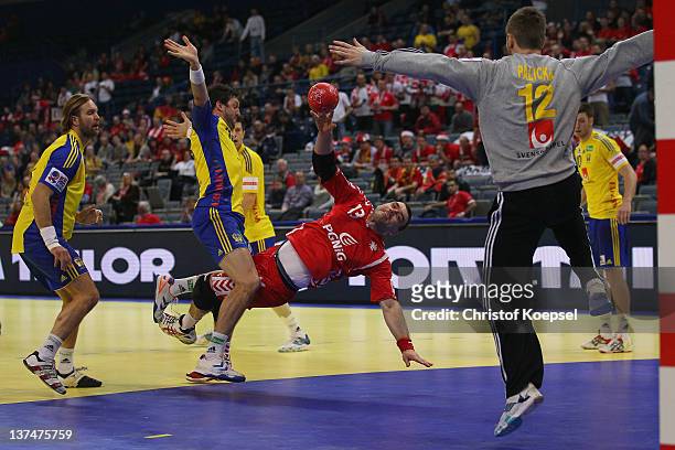 Bartosz Jurecki of Poland scores a goal Andreas Palicka of Sweden and Kim Andersson of Sweden during the Men's European Handball Championship second...