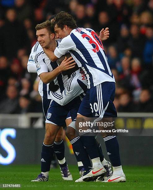 James Morrison of West Bromwich Albion is congratulated on his goal by Gabriel Tamas during the Barclays Premier League match between Stoke City and...