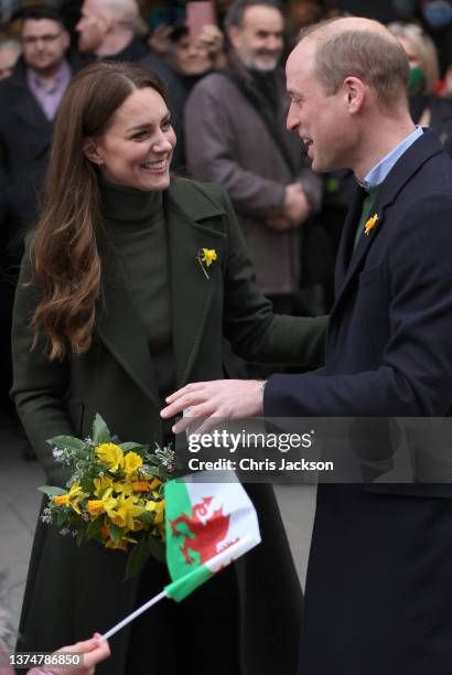 Prince William, Duke of Cambridge and Catherine, Duchess of Cambridge laugh as they meet well-wishers during a visit to Abergavenny Market to see how...