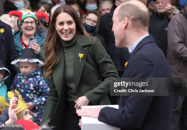 Prince William, Duke of Cambridge and Catherine, Duchess of Cambridge laugh as they meet well-wishers during a visit to Abergavenny Market to see how...