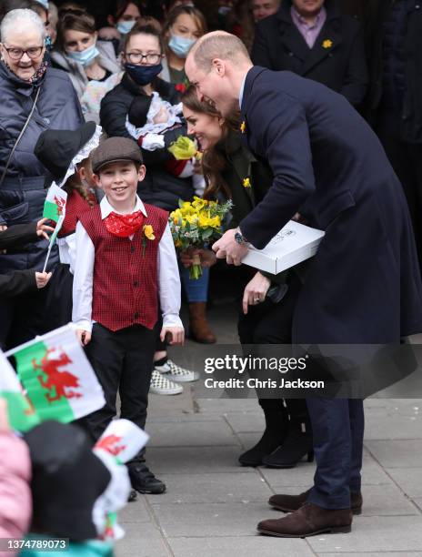 Prince William, Duke of Cambridge laughs a young well-wisher during a visit to Abergavenny Market with Catherine, Duchess of Cambridge, to see how...