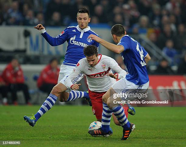 Marco Hoeger of Schalke and teammate Kyriakos Papadopoulos challenge Martin Harnik of Stuttgart during the Bundesliga match between FC Schalke 04 and...