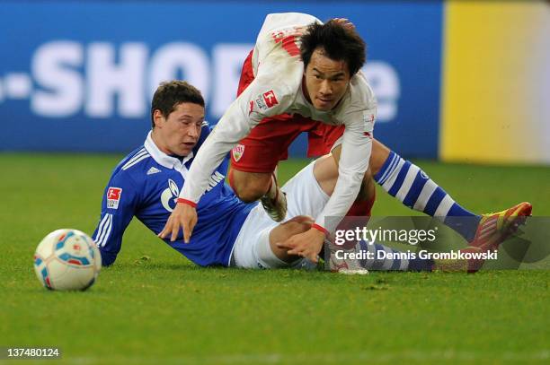 Julian Draxler of Schalke is challenged by Shinji Okazaki of Stuttgart during the Bundesliga match between FC Schalke 04 and VfB Stuttgart at Veltins...