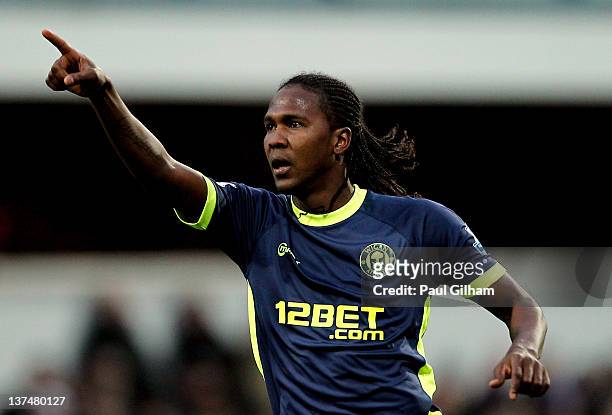 Hugo Rodallega of Wigan celebrates after scoring a goal from a free kick during the Barclays Premier League match between Queens Park Rangers and...
