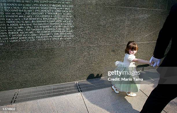 Patricia Mary Smith, daughter of NYPD officer Moira Smith, who was killed in the September 11th terrorist attacks, walks past the police memorial...