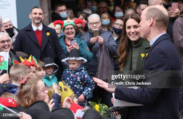 Prince William, Duke of Cambridge and Catherine, Duchess of Cambridge laugh as they meet well-wishers during a visit to Abergavenny Market to see how...