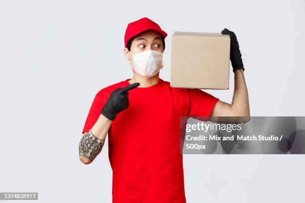 concept of delivery and carriers during coronavirus pandemic - funny surgical masks stock pictures, royalty-free photos & images