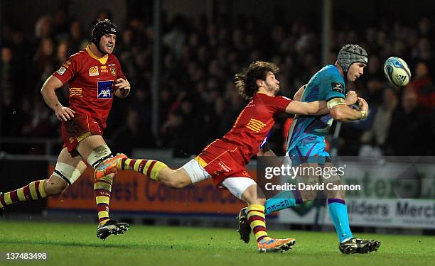 Richard Baxter of Exeter Chiefs is tackled by Florian Cazenave of Perpignan during the Amlin Challenge Cup match between Exeter Chiefs and Perpignan...